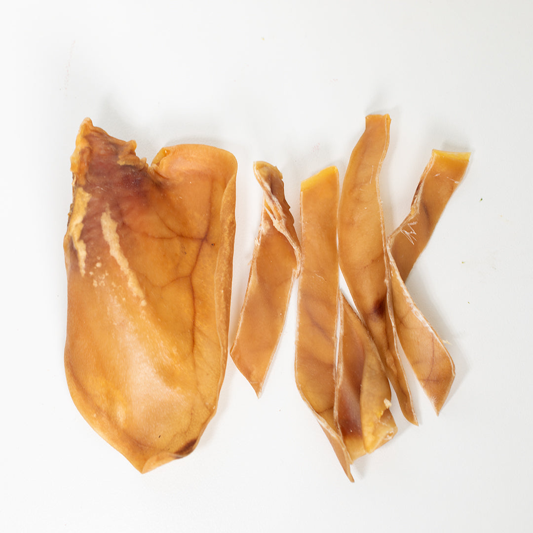 Pig ear strips next to whole pig ears